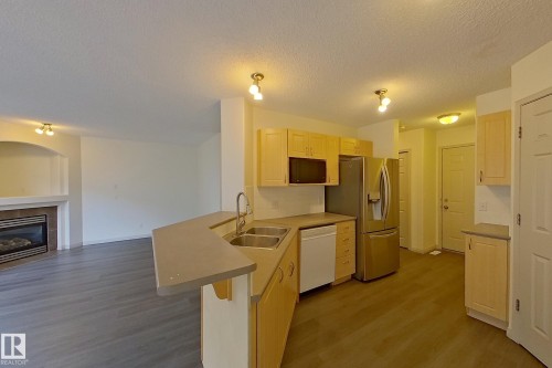 57 155 Crocus Crescent, Sherwood Park, AB - Indoor Photo Showing Kitchen With Fireplace With Double Sink
