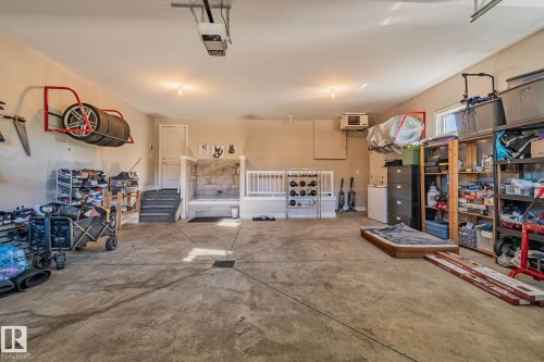 Spacious garage featuring a concrete floor, overhead lighting, and an overhead garage door opener - 67 Enchanted Way Nw, St. Albert, AB - Indoor Photo Showing Garage