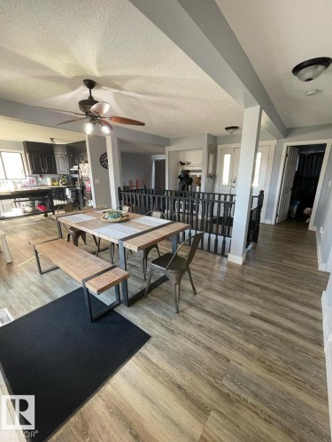 Open-concept dining area featuring wood-finish flooring - 5108 58 Avenue, Elk Point, AB - Indoor