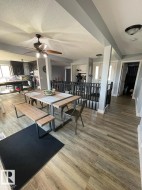 Open-concept dining area featuring wood-finish flooring - 
