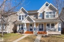Two-story duplex featuring neutral-toned siding and contrasting dark entry doors - 7114 22 Avenue, Edmonton, AB  - Outdoor With Deck Patio Veranda With Facade 