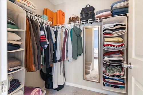 Built-in closet system with wire shelving, hanging rods, and integrated fabric storage units - 7114 22 Avenue, Edmonton, AB - Indoor With Storage