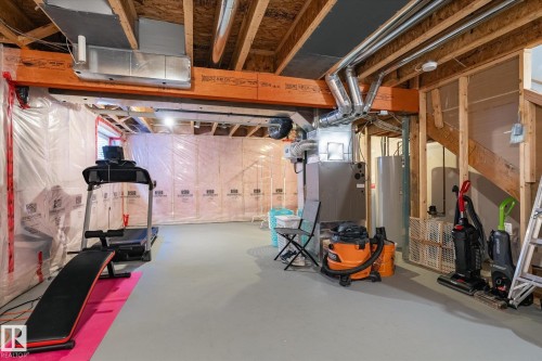Unfinished basement with exposed wooden beams, ductwork, and structural elements - 7114 22 Avenue, Edmonton, AB - Indoor Photo Showing Basement