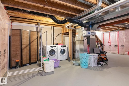 Unfinished basement featuring exposed wood beams, concrete flooring, and visible ductwork - 7114 22 Avenue, Edmonton, AB - Indoor Photo Showing Basement