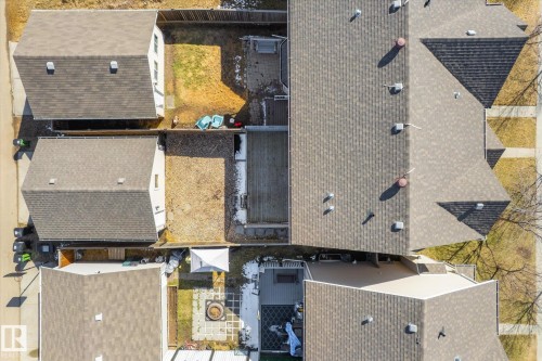 Aerial perspective showcasing multiple residential properties with shingle roofing and private backyard spaces - 7114 22 Avenue, Edmonton, AB - Outdoor With Exterior