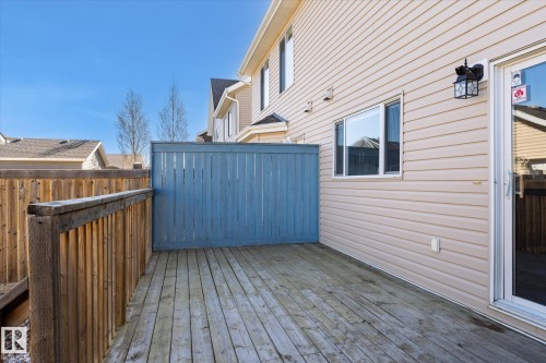 Exterior deck featuring wood flooring and a privacy fence - 7114 22 Avenue, Edmonton, AB - Outdoor With Exterior