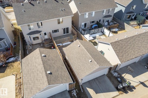 Rear exterior featuring a bay window, a wooden deck, and a fenced yard - 7114 22 Avenue, Edmonton, AB - Outdoor With Deck Patio Veranda