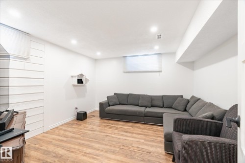 Living area featuring light wood tone flooring, recessed lighting, and a window with blinds - 12823 81 Street, Edmonton, AB - Indoor