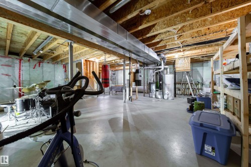 Unfinished basement featuring exposed wood joists, concrete flooring, and metal ductwork - 1205 Ormsby Lane, Edmonton, AB - Indoor Photo Showing Basement