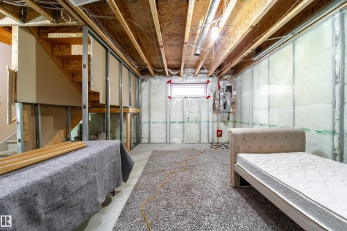 Unfinished basement with exposed wood joists and staircase framing - 1205 Ormsby Lane, Edmonton, AB - Indoor Photo Showing Basement