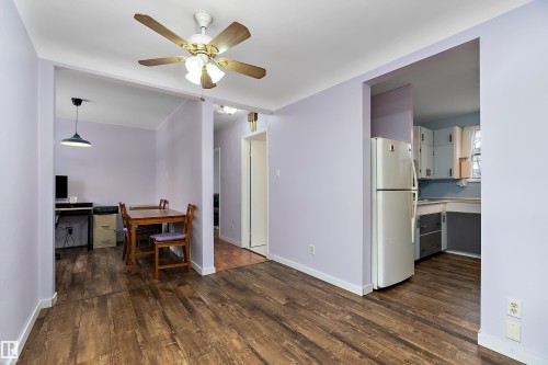 The property features wood-style flooring and light purple walls throughout - 7720 85 Avenue, Edmonton, AB - Indoor