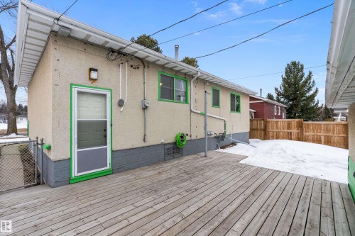 The property features a spacious deck, stucco exterior, and a fenced yard - 7720 85 Avenue, Edmonton, AB - Outdoor With Exterior