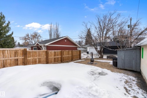 The property features a fenced yard with a storage shed and a fire pit - 7720 85 Avenue, Edmonton, AB - Outdoor
