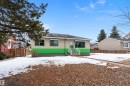 The property features a front yard with a concrete walkway leading to the entrance, and a mature evergreen tree - 7720 85 Avenue, Edmonton, AB  - Outdoor 