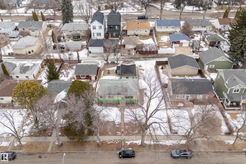 Aerial view of the property and surrounding neighborhood, featuring residential homes with pitched roofs and bare trees along the street - 7720 85 Avenue, Edmonton, AB - Outdoor With View