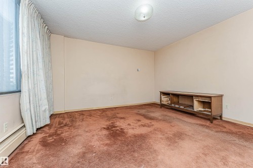 Spacious room with a large window and full-height drapery - 407 10045 118 Street, Edmonton, AB - Indoor Photo Showing Other Room