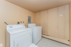 Dedicated laundry area featuring a washer and dryer, vinyl flooring, and baseboard heating - 