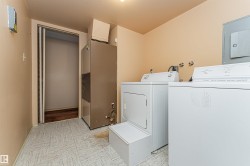 Dedicated laundry area featuring a washer and dryer, utility sink connections, and patterned vinyl flooring - 