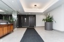 Well-lit communal hallway featuring dual elevators, recessed ceiling lights, a contemporary light fixture, and light-toned floor tiles - 407 10045 118 Street, Edmonton, AB  - Indoor Photo Showing Other Room 