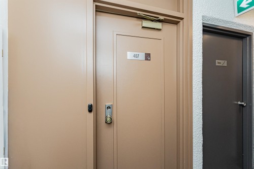Entry door with brass hardware and a privacy peephole - 407 10045 118 Street, Edmonton, AB -  Photo Showing Other Room