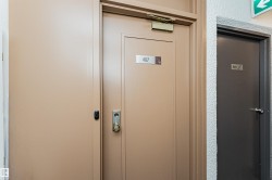 Entry door with brass hardware and a privacy peephole - 