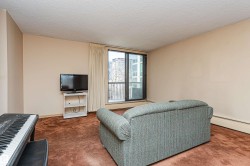 Spacious room featuring a full-height window, broad wall space, textured ceiling, and baseboard heating - 