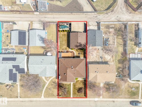 Property parcel featuring a main residence with a gabled roof, an auxiliary structure, a swimming pool, and concrete hardscaping - 1027 77 Street, Edmonton, AB - Other