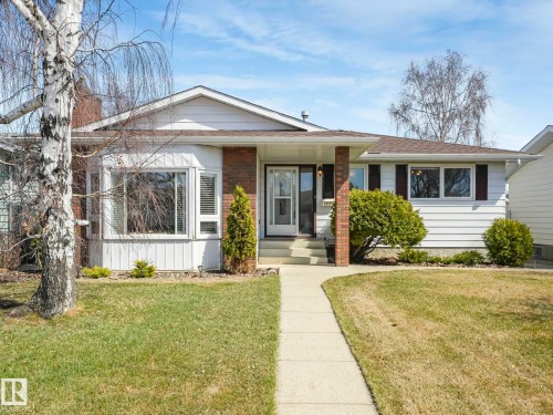 Ranch-style residence featuring white siding, brick accents, and a front walkway - 1027 77 Street, Edmonton, AB - Outdoor With Facade