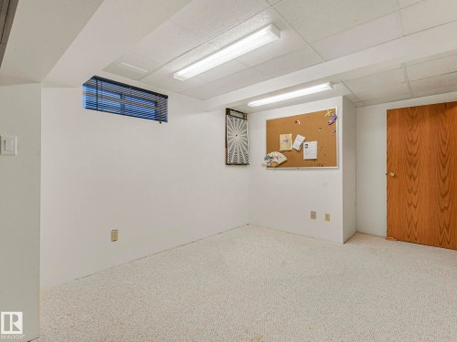 Windowed space featuring wall-to-wall carpeting and a textured acoustic ceiling - 1027 77 Street, Edmonton, AB - Indoor