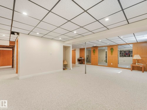 Spacious carpeted area with recessed lighting and a drop-panel ceiling - 1027 77 Street, Edmonton, AB - Indoor