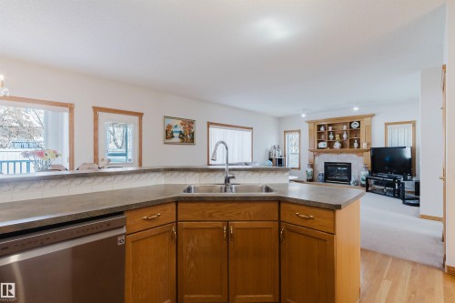 8608 160A Avenue, Edmonton, AB - Indoor Photo Showing Kitchen With Fireplace With Double Sink
