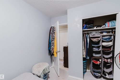Built-in closet with hanging rod and upper shelf - 10519 36A Avenue, Edmonton, AB - Indoor