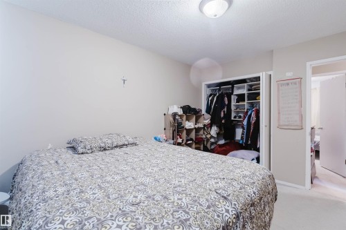 Bedroom featuring light beige walls and textured white ceiling - 10519 36A Avenue, Edmonton, AB - Indoor Photo Showing Bedroom