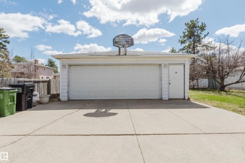 Detached garage with a white overhead door and a white side entry door - 10519 36A Avenue, Edmonton, AB - Outdoor