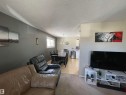Open-concept living area featuring a neutral color palette, natural light, and a dining space - 10519 36A Avenue, Edmonton, AB  - Indoor Photo Showing Living Room 