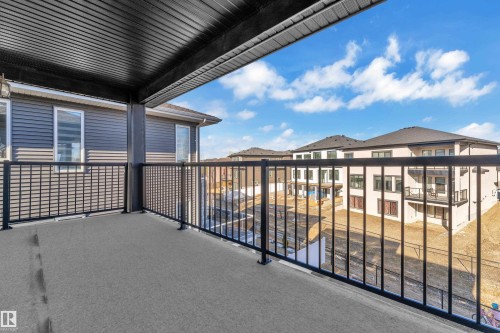 Outdoor balcony with durable surface, black metal railings, and a soffit ceiling - 4403 Triomphe Gate, Beaumont, AB - Outdoor With Exterior