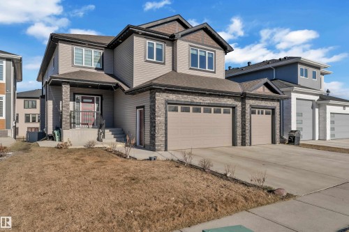 Contemporary two-story residence featuring a multi-tone exterior with horizontal siding and stone accents - 4403 Triomphe Gate, Beaumont, AB - Outdoor With Facade