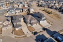 Contemporary suburban residence featuring multi-level design, attached two-car garage, concrete driveway, and a front yard with undeveloped landscaping - 4403 Triomphe Gate, Beaumont, AB  - Outdoor With View 