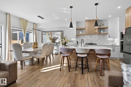 Open-concept kitchen and dining area featuring light wood-finish flooring - 3605 42 Avenue, Beaumont, AB - Indoor