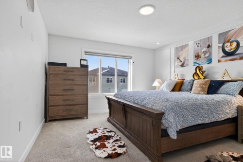 Bedroom with a large window, light-colored walls, recessed lighting, and carpet flooring - 3605 42 Avenue, Beaumont, AB - Indoor Photo Showing Bedroom