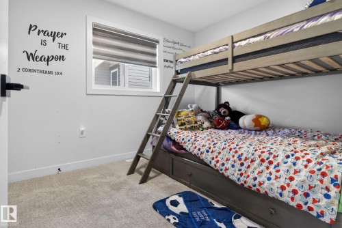 Bedroom featuring a window with horizontal blinds, light gray walls, and carpeting - 3605 42 Avenue, Beaumont, AB - Indoor Photo Showing Bedroom