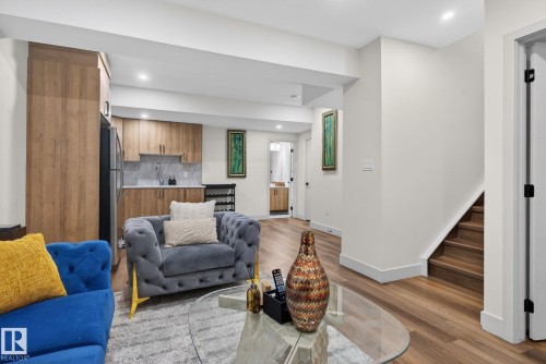 Open concept living area featuring wood-finish flooring, recessed lighting, and white baseboards - 3605 42 Avenue, Beaumont, AB - Indoor Photo Showing Living Room