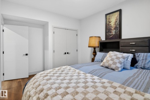 White interior doors with matte black hardware - 3605 42 Avenue, Beaumont, AB - Indoor Photo Showing Bedroom