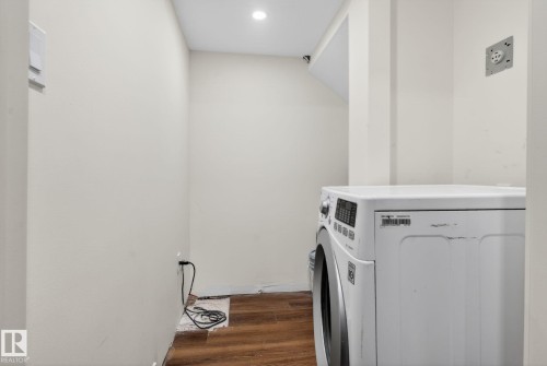 Dedicated laundry area featuring wood-finish flooring and a recessed ceiling light - 3605 42 Avenue, Beaumont, AB - Indoor Photo Showing Laundry Room