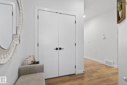 Entryway featuring wood-finish flooring, white walls, and bright overhead lighting - 3605 42 Avenue, Beaumont, AB - Indoor Photo Showing Other Room