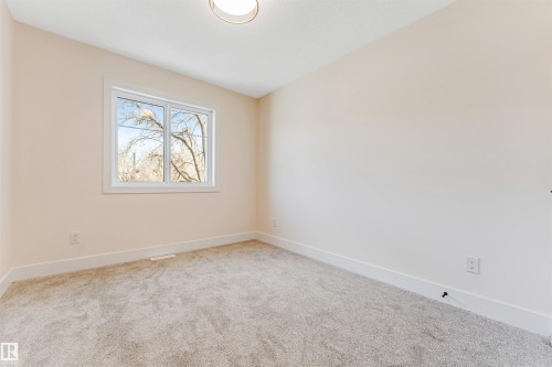 Room featuring neutral tone walls, light gray carpet, white trim, and a contemporary ceiling light fixture - 10323 79 Street, Edmonton, AB - Indoor Photo Showing Other Room