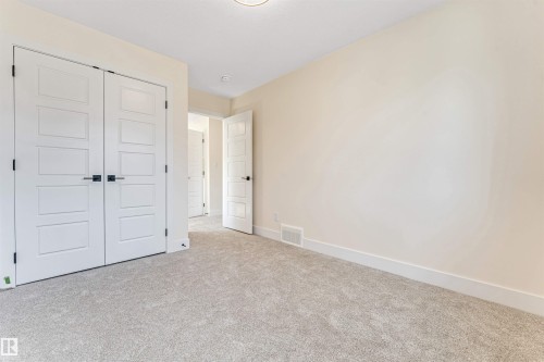 Neutral-toned wall paint complemented by bright white trim and baseboards - 10323 79 Street, Edmonton, AB - Indoor Photo Showing Other Room