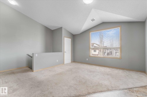 Open-concept living space featuring a kitchen with light wood cabinetry and black appliances - 86 604 62 Street, Edmonton, AB - Indoor Photo Showing Kitchen