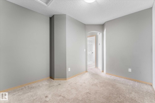 Utility area featuring a wall-mounted water heater system with copper piping and a tiled floor - 86 604 62 Street, Edmonton, AB - Indoor Photo Showing Other Room