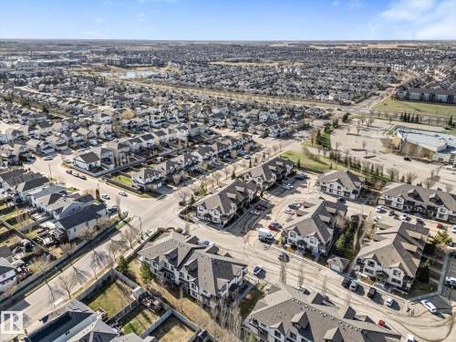 Expansive aerial view of a residential neighborhood featuring a mix of single-family homes and multi-story condominium buildings - 86 604 62 Street, Edmonton, AB - Outdoor With View